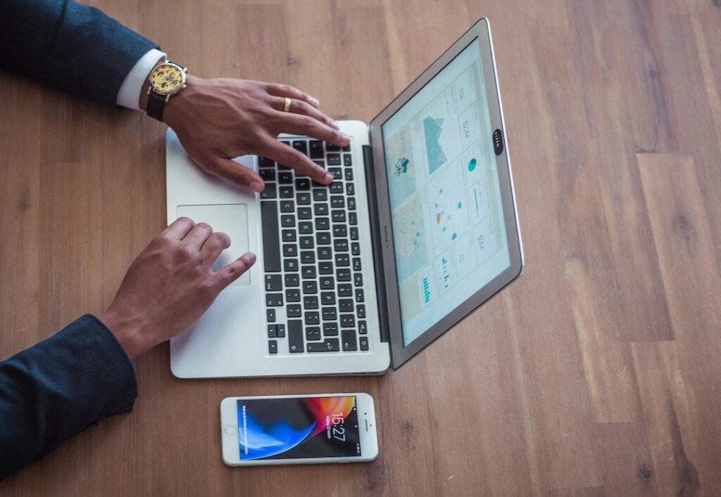 Businessman using laptop to learn what is resource forecasting